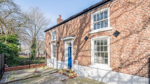 A brick house with a blue door, a small porch, and a stone pathway. - Home from home in style & comfort (Chester)