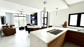 A modern living space with a kitchen, dining area, and seating area.