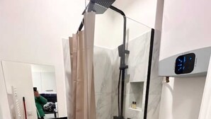 A modern bathroom with a glass-enclosed shower, a toilet, and a vanity with a mirror. - Studio Annah - Studio Apartment, Sleeps 3 (Paris)