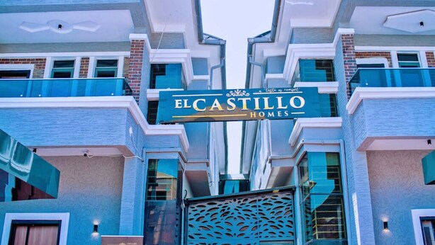 A modern building with a sign reading "ELCASTILLO HOMES". - El Castillo Pretigious Hotel (Lekki)