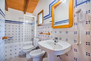 A bathroom with a white sink, two toilets, a shower, and a mirror with a wooden frame. - Cuixac, A Quiet Country Villa IN Pollensa (Pollença)