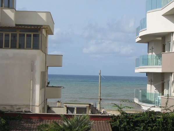 A coastal building with balconies overlooking the sea.