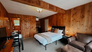 A room with a bed, a desk, a chair, and a nightstand. - Waters Edge Lodge (Diamond Point)