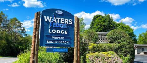 A sign for Waters Edge Lodge, indicating it is a private property with a vacancy.