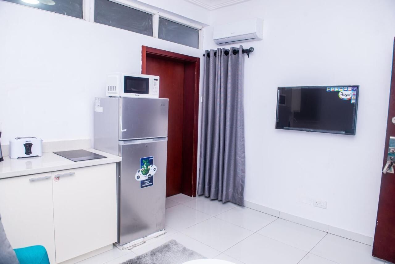 A compact kitchen with a microwave, toaster, and refrigerator.