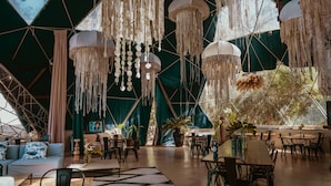 A spacious, tent-like interior with hanging decorations, a central seating area, and natural light from large windows. - Big Bang Nature Stays (Sauce de Portezuelo)