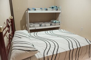 A bunk bed with a lower bunk and a single bed.