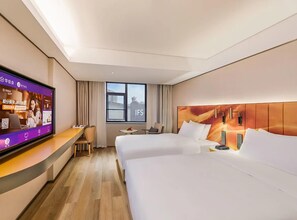 A hotel room with two beds, a TV, a desk, and a window with a view. - Manxin Hotel Changsha IFS (Changsha)