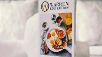 A book cover with the title 'Warren Collection' and a depiction of a meal.
