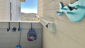 A small balcony with a view of a house and a clear sky. - Rita’s Rejuvenating Oceanfront- Pool- Hot tub- Corner unit-Sleeps 6- APATB  (Atlantic Beach)