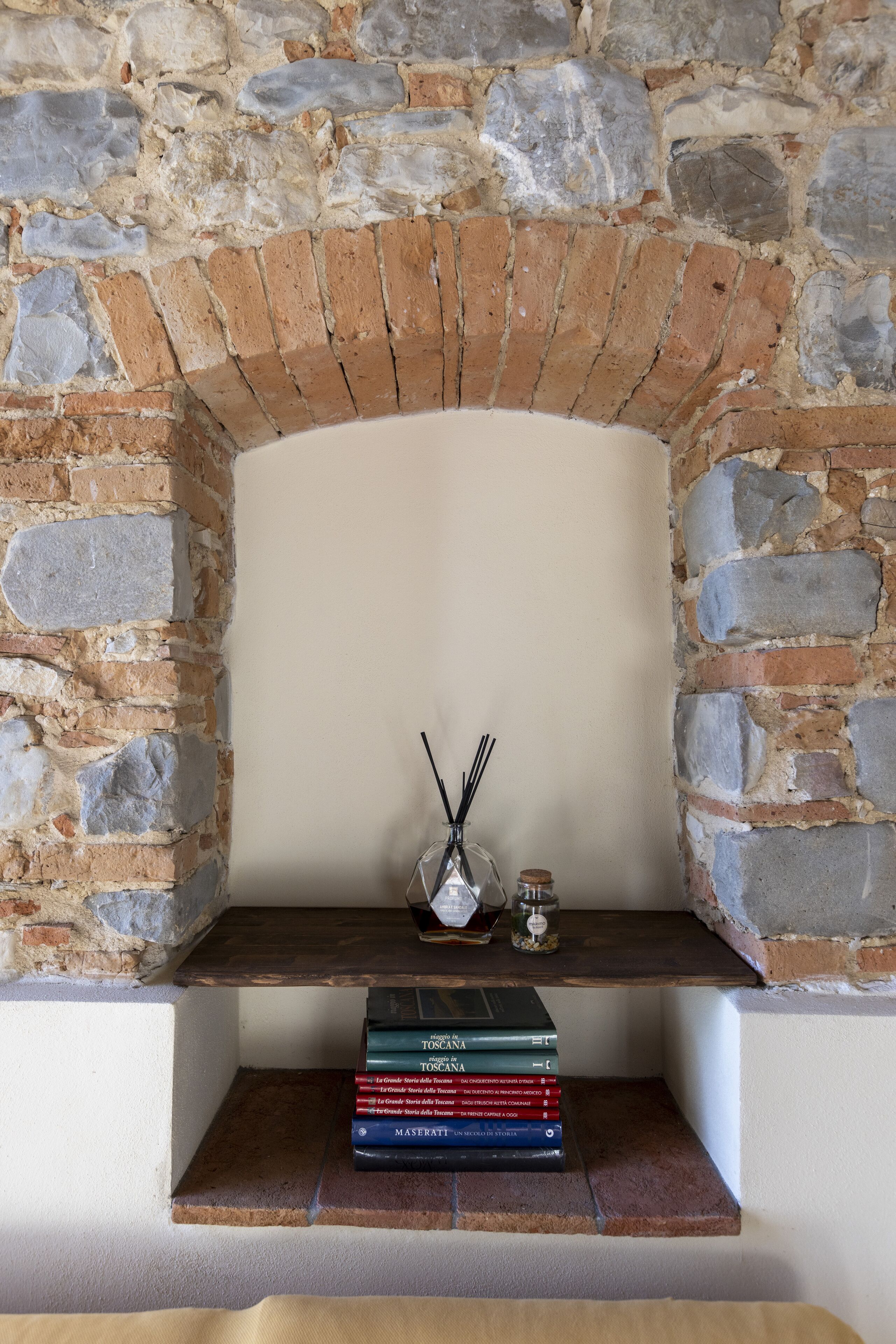 A stone fireplace with a shelf below it.