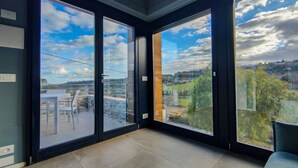 A room with large sliding glass doors leading to an outdoor patio with a table and chairs. - [Luxury & Relaxation] Private Pool with View (Civitanova MARCHE)