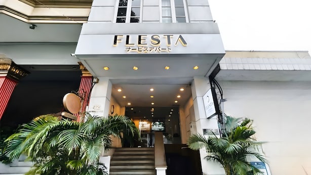 The exterior of a building with a sign reading "FLESTA" and a staircase leading to the entrance. - FLESTA Lê Thánh Tôn serviced apartment (Ho Chi Minh City)