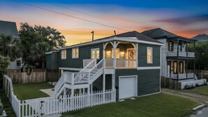 A two-story house with a front porch, a staircase, and a garage.