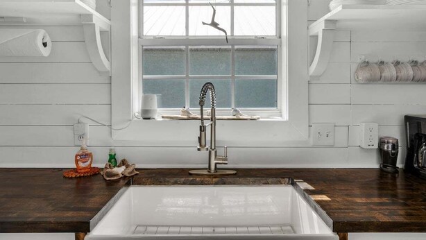 A kitchen with a large window, a modern faucet, and wooden countertops. - Summer Available! Private Pool, Private Home 6min walk to the Beach! (Panama City Beach)