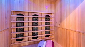 A sauna with wooden walls and a bench.