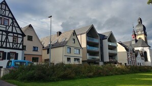 A row of traditional and modern buildings with a church tower in the background. - Holiday Apartment 'Ferienhaus Rheinblick Wohnung 4' with Shared Terrace, Wi-Fi and Air Conditioning (Koblenz)