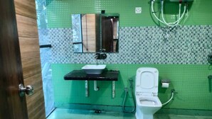 A bathroom with a toilet, sink, and shower. - Hotel Lake In Tree (Nainital)