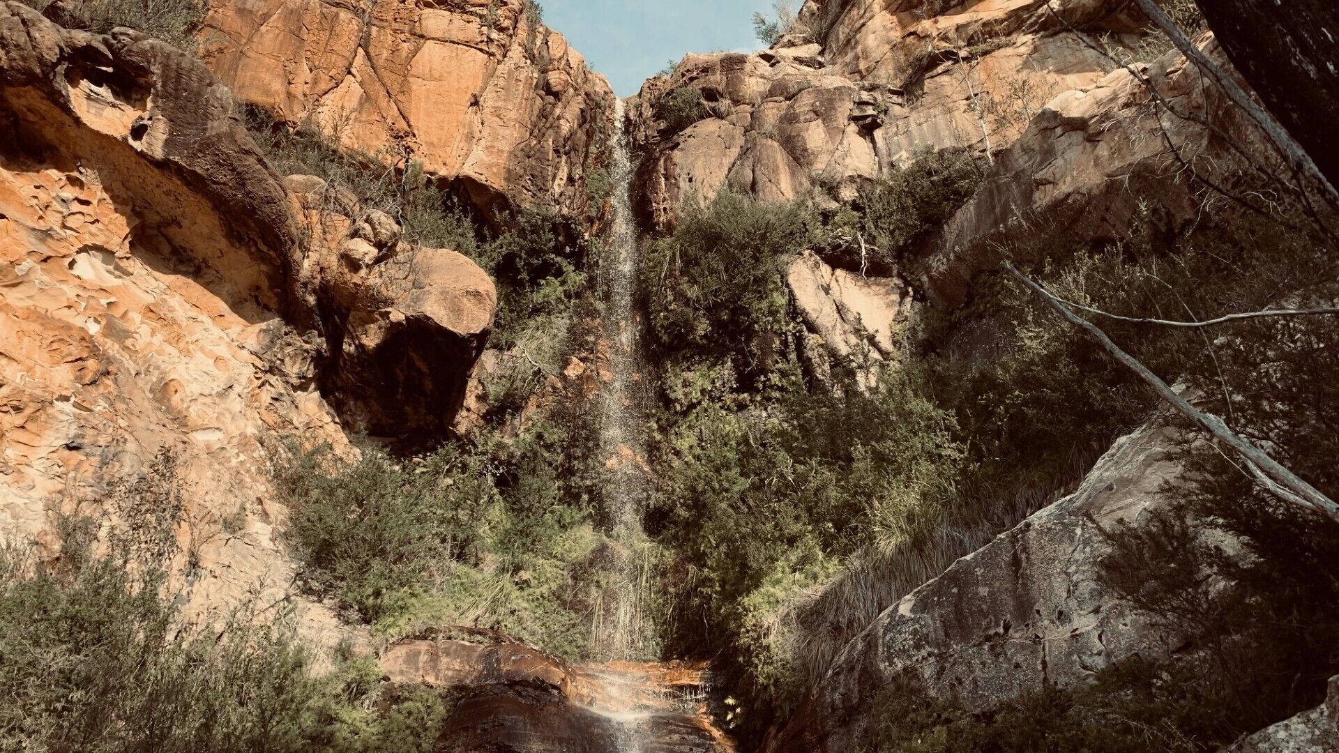 A natural rock formation with a waterfall.