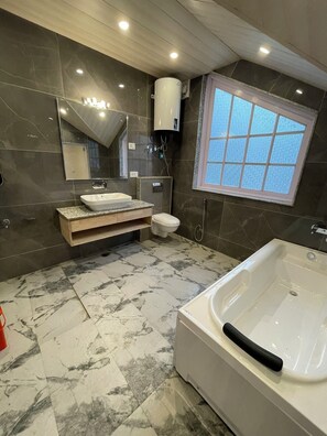 Deluxe Room | Bathroom | Hair dryer, slippers, towels, soap