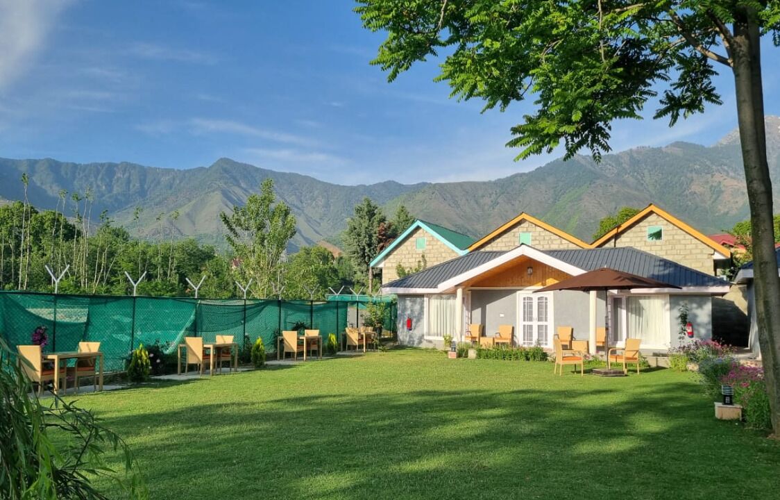 A house with a garden and mountain views.