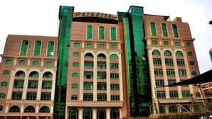 A multi-story hotel with a prominent 'Paradise' sign on the top. - paradise home city stars (Cairo)