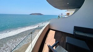 Un balcón con vista al mar y una isla en la distancia.
