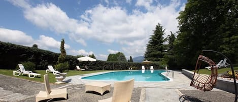 Seasonal outdoor pool, open 9:30 AM to 7:00 PM, pool umbrellas