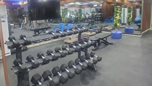 A gym with various exercise equipment, including dumbbells and benches. - Armed Forces Officers Mess & Suites (Abuja)