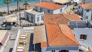 A coastal building with a tiled roof, a balcony, and a view of the sea. - Teresa Spetses (Spetses)