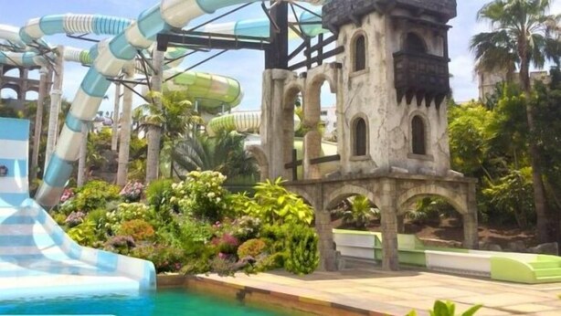 A water park with multiple water slides and a castle-like structure. - Tess Dreamlike Mirador with Panoramic Views (Costa Adeje)