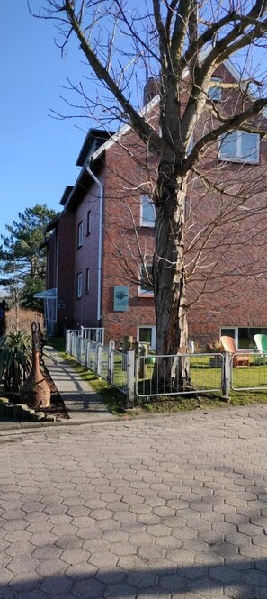 Stroll along the paved walkway to this charming brick building.