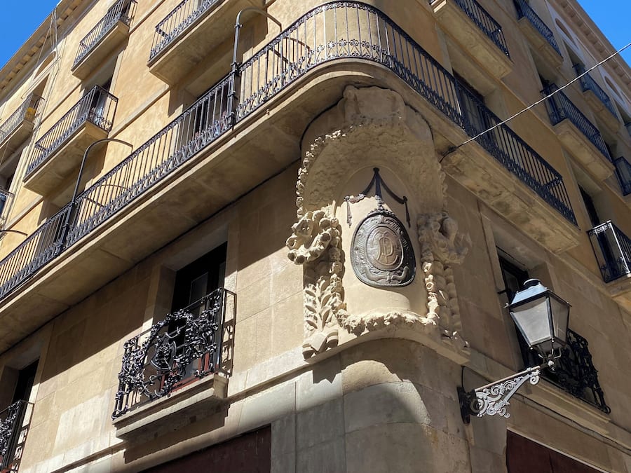 A multi-story building with ornate balconies and a decorative facade.