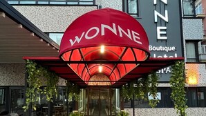The entrance of the boutique hotel with a distinctive red canopy and a glass facade. - Wonne Boutique Hotel (Ankara)