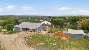 A residential area with houses, a fenced yard, and a clear sky.