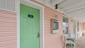 A green door labeled "Laundry Room" with a window and a water dispenser on the adjacent wall. - TreeHouse Lodge, Walk to Beach, Pet-Friendly 201 (North Myrtle Beach)
