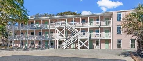 A multi-story motel with balconies and a central staircase.
