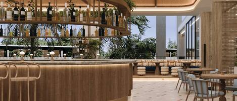 A modern bar area with a curved counter, multiple seating options, and a variety of bottles on shelves.