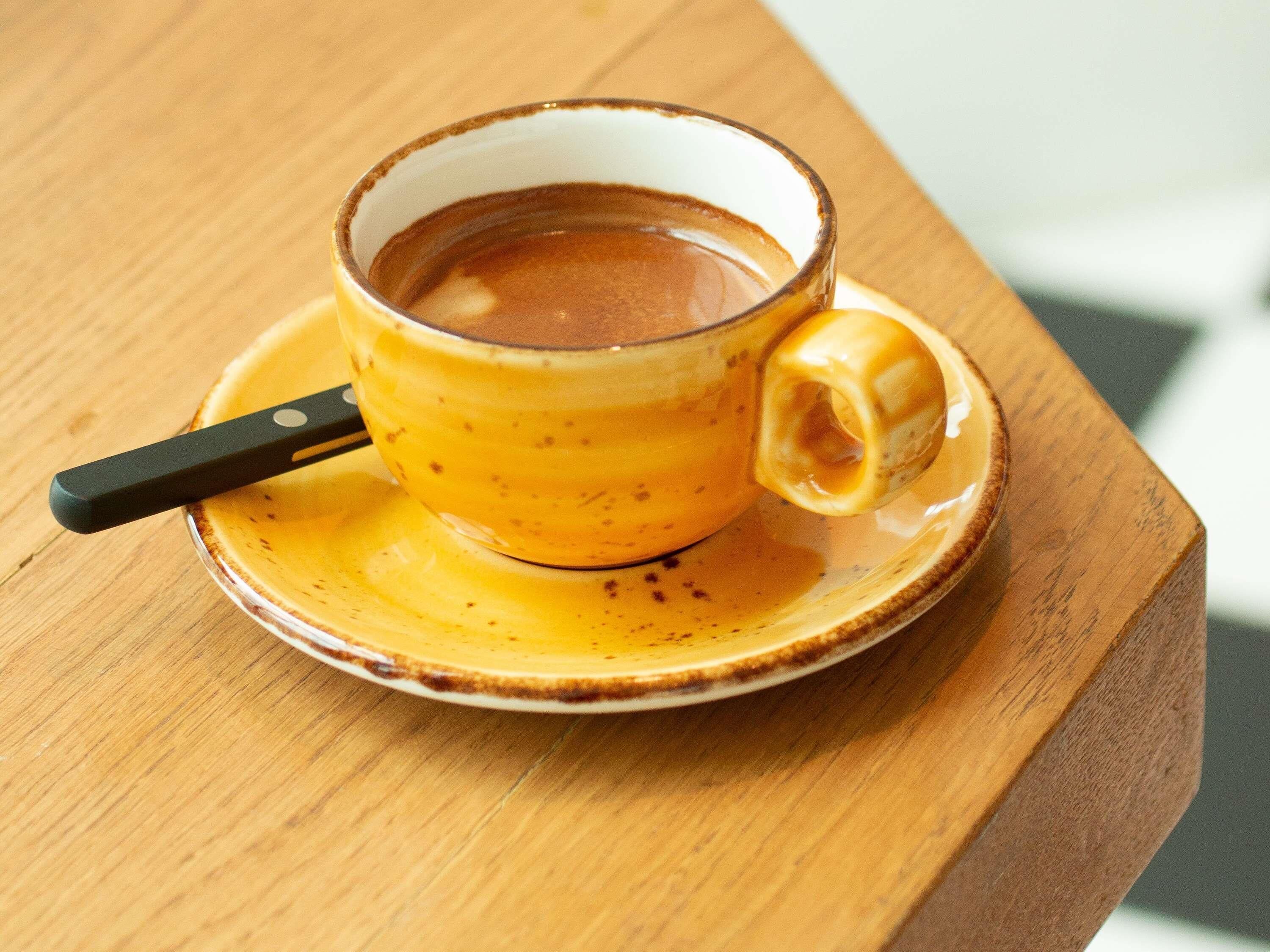 A cup of coffee on a saucer.