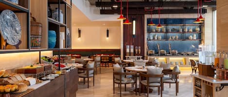 A restaurant with wooden furniture, a buffet area, and shelves with decorative items.
