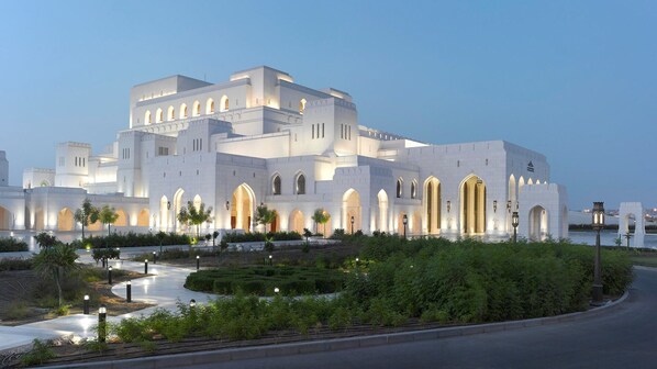 A large, white building with multiple arches and a central courtyard. - Mövenpick Hotel And Hotel Apartments Ghala Muscat (Muscat)