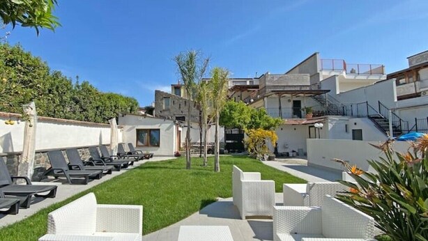 A courtyard with outdoor seating, a pool, and a staircase leading to upper levels. - Terrace on VESUVIO/Pompei - Mini Suite (Terzigno)