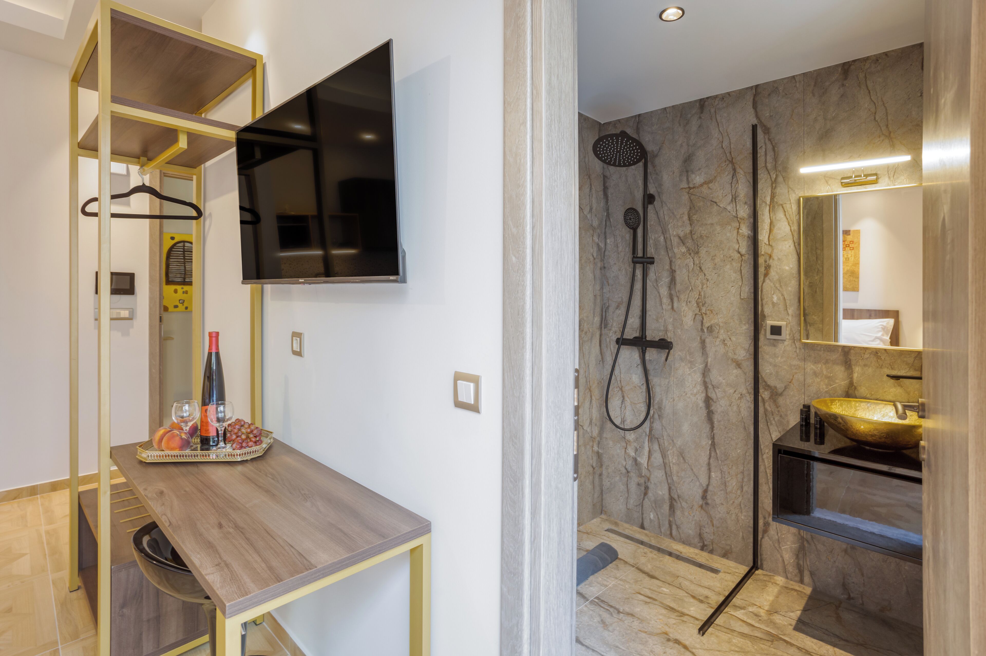 A modern bathroom with a marble shower, a large mirror, and a wooden vanity.