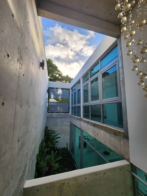 A modern building with large windows and a concrete exterior. - Torremar Luxury Villa: A Luxurious Coastal Escape for Adults (Isabela)