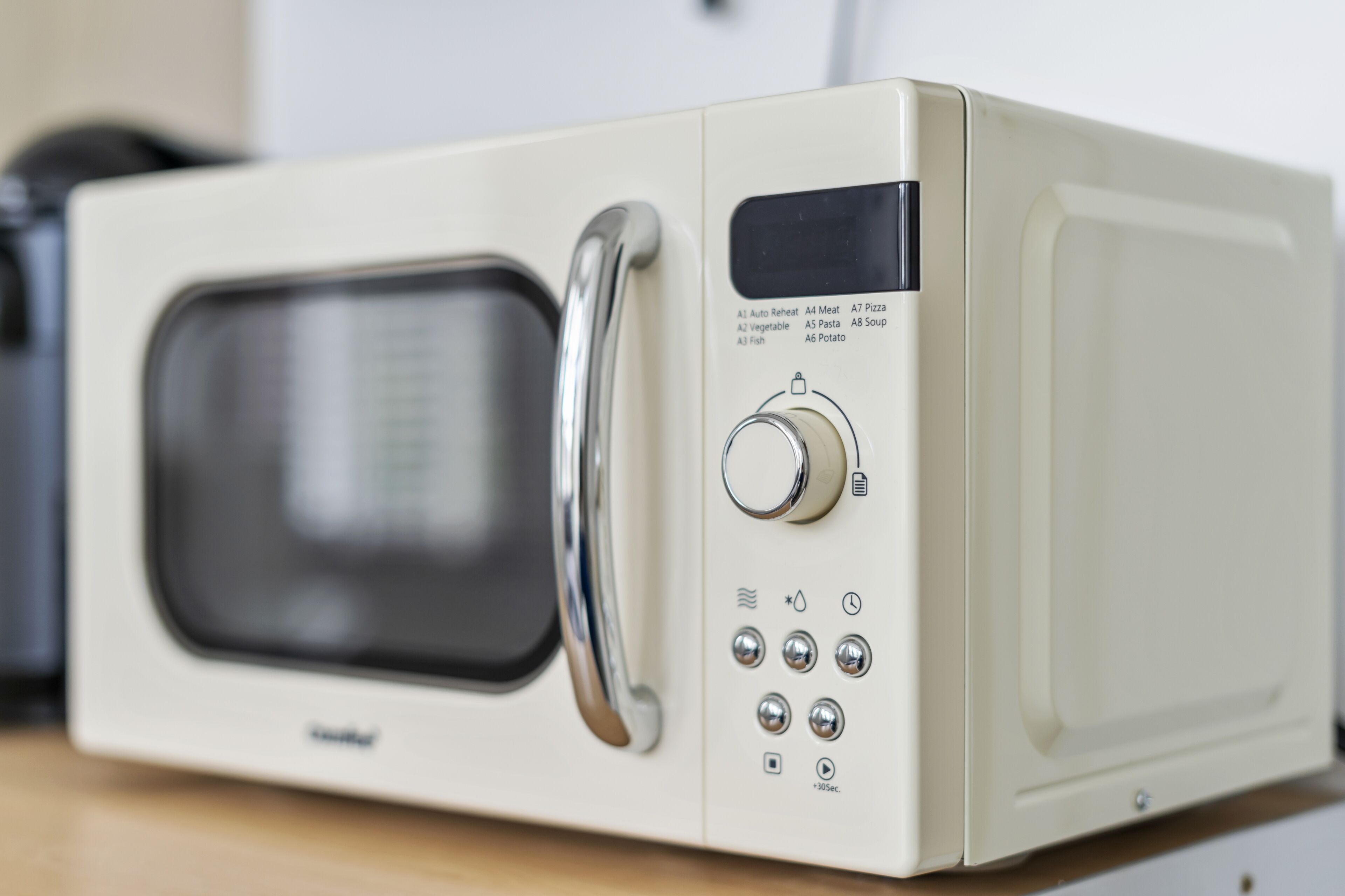 Un four à micro-ondes blanc doté d’un écran numérique, d’un cadran et de plusieurs boutons.