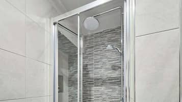 Shower, hair dryer, towels, shampoo