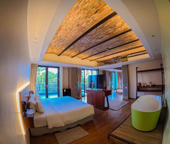 Un dormitorio moderno con una cama grande, una bañera verde y vistas al exterior.