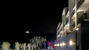 A modern hotel with multiple floors, balconies, and a well-lit exterior. - Chance Villa 261 (Toucheng)