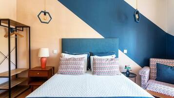 A bedroom with a bed, bedside tables, a dresser, and a chair.