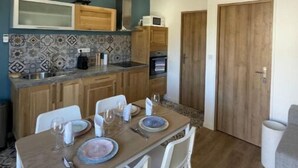 Una cocina compacta con armarios de madera, microondas y un salpicadero con diseño.